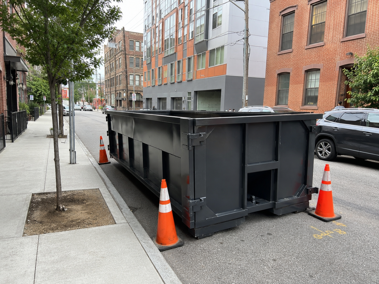 Roll-off dumpster placed along a residential street